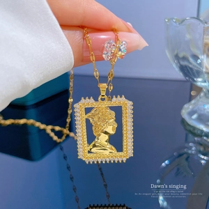 Detailed view of a gold-plated portrait pendant necklace with micro-paved zirconia frame