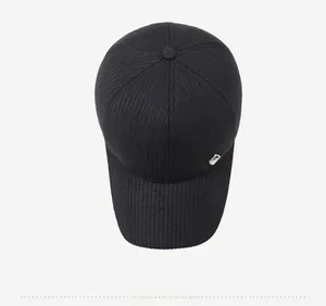 Top view of a black winter baseball cap with ear flaps and fine vertical stripe texture