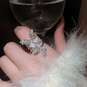 Exquisite close-up of double butterfly silver ring with pavé-set crystals on hand