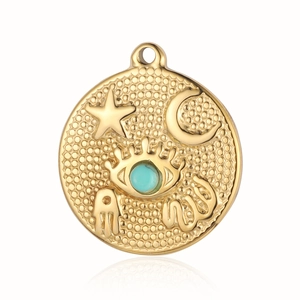 Macro shot of gold sun and moon pendant with turquoise evil eye and hammered metal finish