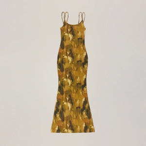 Detailed flat lay of slim fit maxi dress with faded camouflage pattern and thin straps