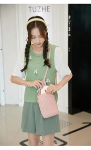 Pink crossbody phone bag for women with cartoon embossed patterns and metal clasp detail
