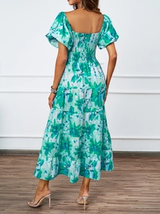 Dettaglio posteriore dell'abito a fiori con punto smock elastico e gonna lunga a balze