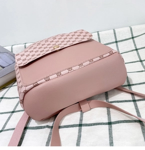 Detail view of the lotus pink leather backpack with vintage floral patterns and gold buckle