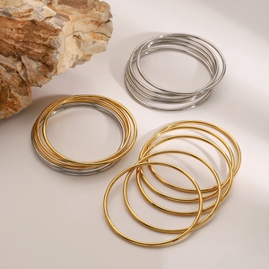 Minimalist stainless steel multilayer bangle set in gold and silver finish on stone
