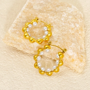 18k gold plated hoop earrings with elegant pearls displayed on a natural stone base