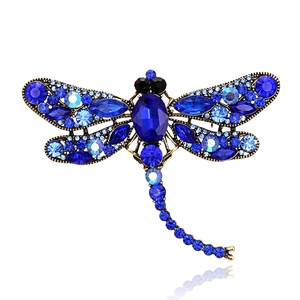Exquisite vintage gold dragonfly brooch featuring deep blue crystals and rhinestones