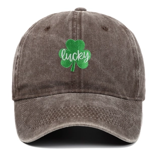 Close-up of green clover and lucky embroidery on dark brown washed cotton baseball cap