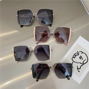 Detail showing oversized square polarized sunglasses in multiple fashion color options