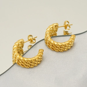 Polished gold twisted rope texture C-shaped hoop earrings on elegant mirrored background