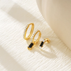 Detailed macro of S925 sterling silver earrings set with 18K gold and black gemstones