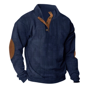 Detail of dark blue corduroy shirt featuring brown leather elbow patches and polo collar