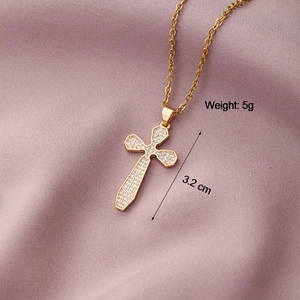 Macro detail of gold cross pendant with cubic zirconia, weighing 5g and 3.2cm in height