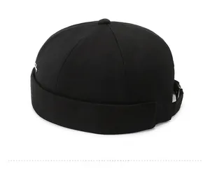 Side view of black docker hat with white geometric embroidery and adjustable metal buckle