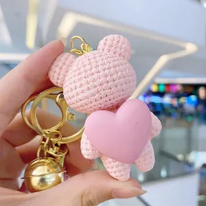 Pink textured bear keychain with heart and gold bell pendant for couples