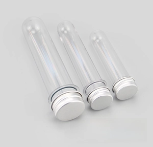 Three sizes of transparent PET test tubes with silver aluminum screw caps on grey surface