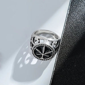 Retro hollow maple leaf ring with black enamel drip design on a modern background