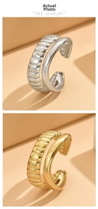 Detail of double-layer stainless steel ring with shell thread texture in gold and silver