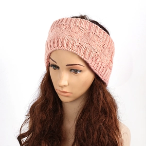 Detail shot of pink cable knit texture on a winter warm thermal ear warmer headband