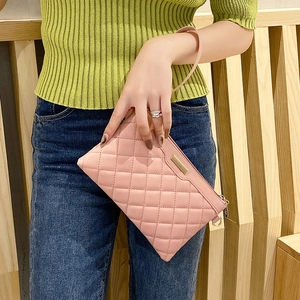 Pink quilted faux leather clutch bag with embroidery and wrist strap for women