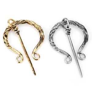 Vintage Viking metal brooches in gold and silver finish with spiral texture on white background