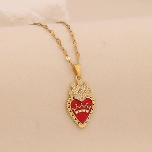 Detailed close-up of a red enamel heart pendant with golden crown and clear rhinestones