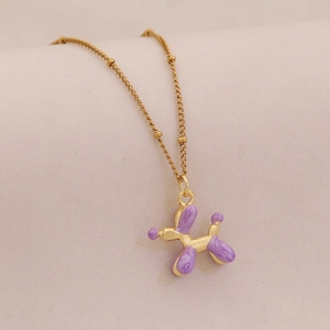 Close-up of golden beaded chain with a purple balloon dog pendant for women