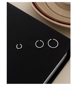 Detailed set of four S999 sterling silver ear cuffs in various sizes on jewelry box