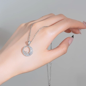 Silver star and moon pendant necklace with zircons shown on hand in a 45-degree angle