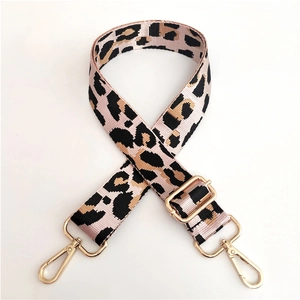 Macro shot of nylon wide leopard print bag strap with adjustable gold lobster clasps