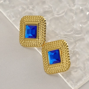 Vintage gold textured rectangle stud earrings featuring deep blue crystals on a ripple surface