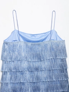 Detail of blue tiered tassel dress featuring metallic luster fabric and thin spaghetti straps