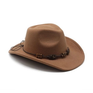 Detail of brown wool felt cowboy hat with vintage wooden beads and carved plate strap