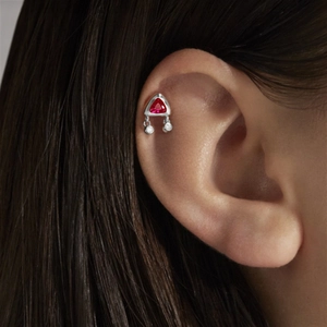 Detail of S925 silver piercing earring with red triangle stone and dangling clear gems