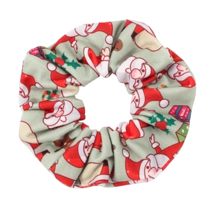 Detail of Christmas scrunchie with Santa and gift prints on soft green fabric