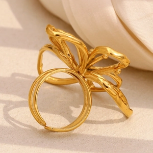 Minimalist 18K gold plated butterfly hollow open ring for women on cream fabric background