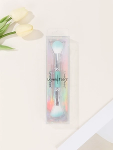 Detailed view of dual-ended powder and highlight brush in holographic packaging