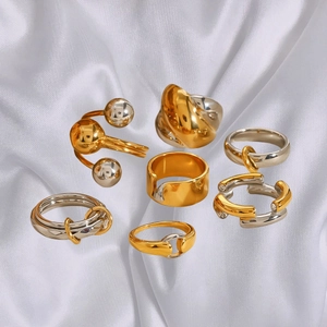 Set of 7 gold and silver mixed metal rings including wide bands and chain styles