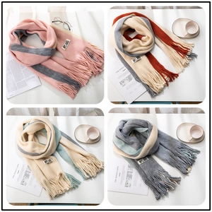 Detailed grid view of four color-block knitted scarves with decorative fringe and labels