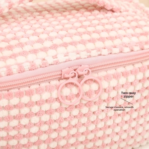 Detail of high-quality dual zipper closure on plush color-block toiletry cosmetic bag