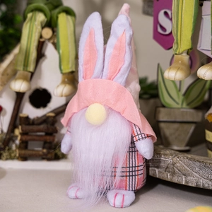 Macro detail of Easter gnome with pink checkered fabric, long rabbit ears and soft white beard