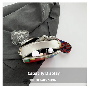 Detail showing internal capacity of white crossbody bag with geometric color blocks