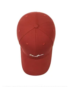 Top view of deep red baseball cap with white cursive letter embroidery on durable canvas