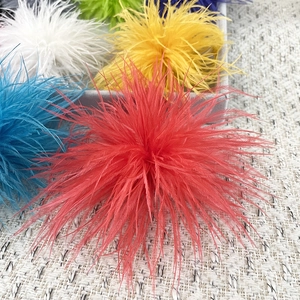 Close-up of colorful fluffy ostrich feather pins in red, blue, and yellow for party dresses
