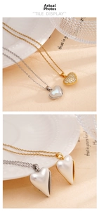 Detail of double-sided heart pendant with pearl inlay and zircon pavé on a steel chain