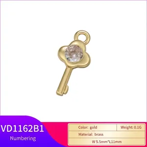 Golden brass key-shaped pendant VD1162B1 with white zircon stone, size 5.5mm by 11mm