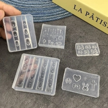 Macro detail of silicone nail art molds with lace and heart patterns for DIY manicure