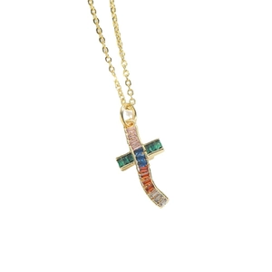 Minimalist gold chain necklace with colorful rainbow zircon cross pendant on white background