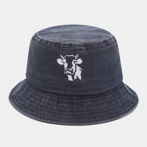 Detail of white cow embroidery on vintage washed grey denim bucket hat with metal eyelets