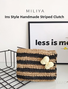 Macro detail of hand-woven striped straw clutch bag with a yellow 3D bow accent